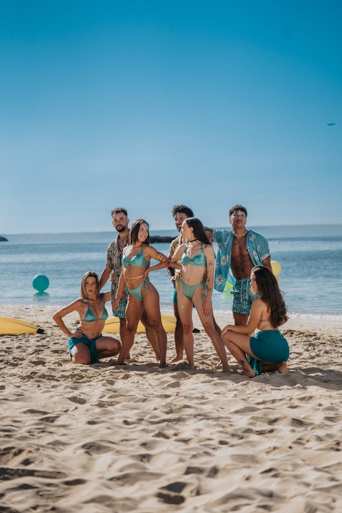 A group of people posing for a photo on the beach